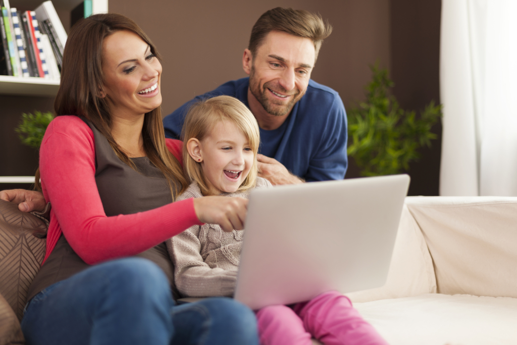 family-laughing-together-using-laptop-home.jpg